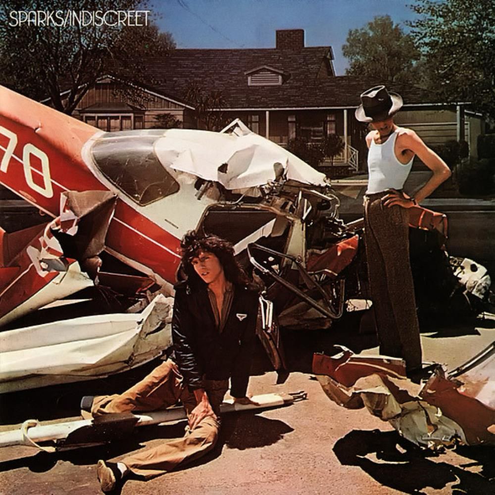 Sparks Indesceet album cover. Two men in front of a crashed Cessna in front of a residential house 