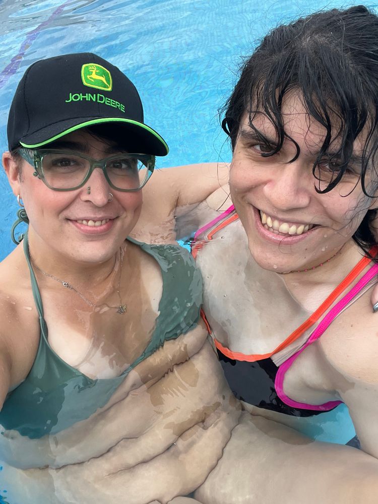 Olivia being held in Vi’s arms at the pool