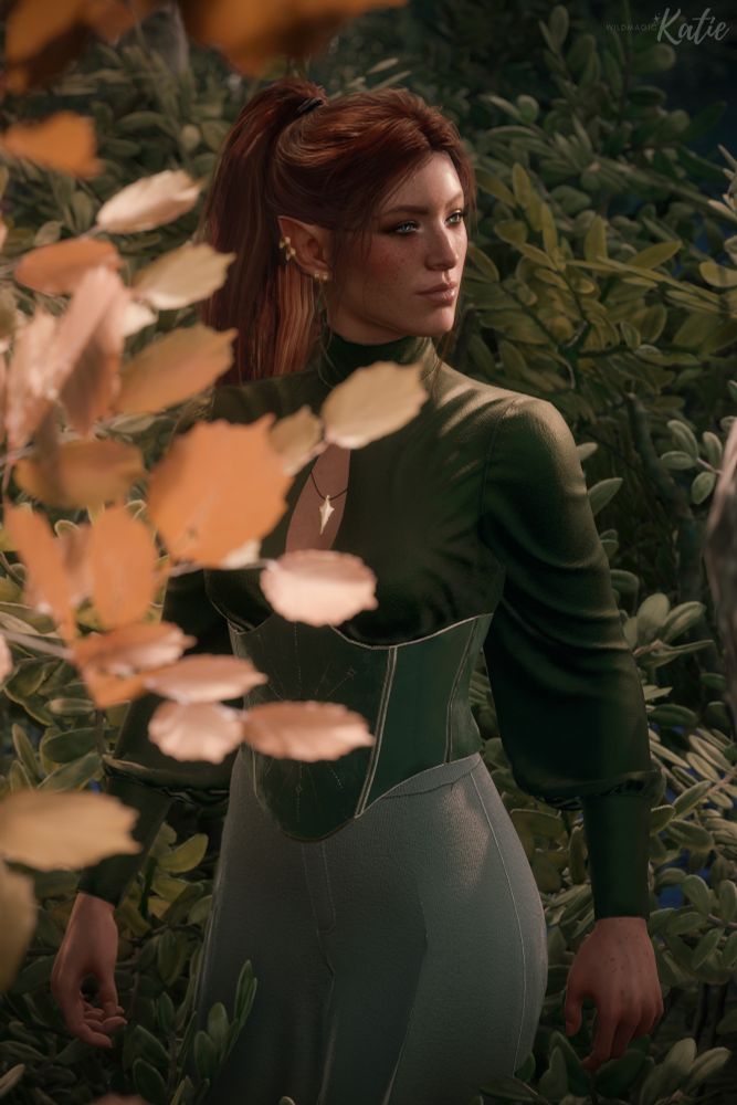 A photo of Willow, a half elf woman with reddish brown hair and blue eyes. She is wearing a green satin blouse with an embroidered corset, grey pants, and gold jewelry. She is surrounded by green and gold leaves. 

Stargazer outfit by Arideyya 