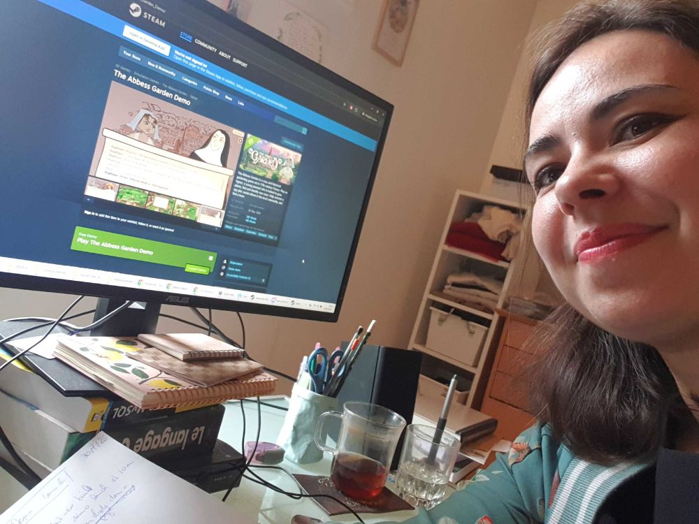 Picture of me in my office, in front of my computer, displaying the Demo page of The Abbess Garden :)