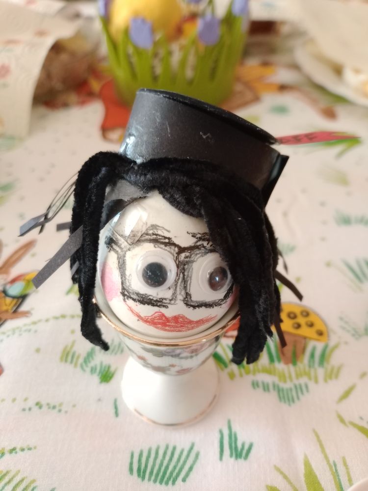 coloured Easter egg showing my daughter with a black office hat