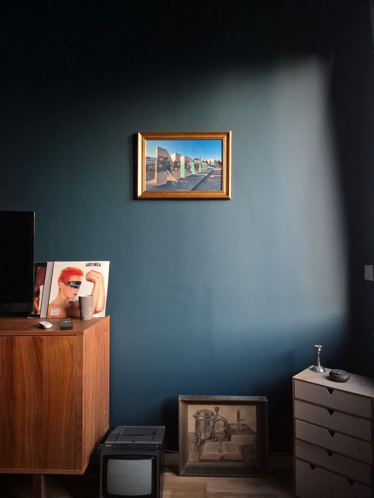 A room with a photo on a wall.