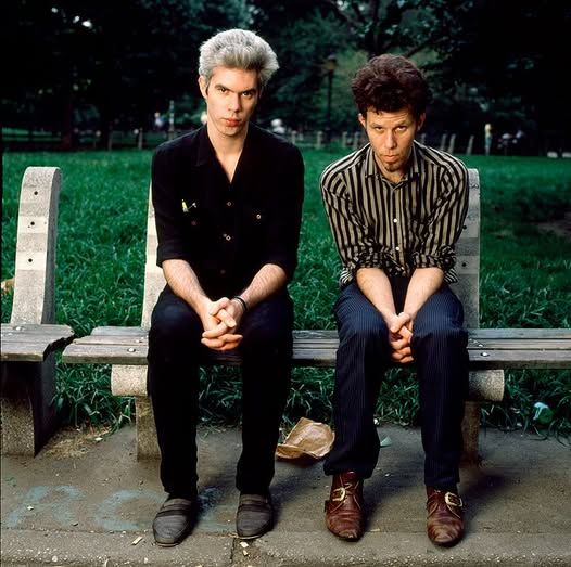 Jim Jarmusch and Tom Waits posing similarly on park bench
