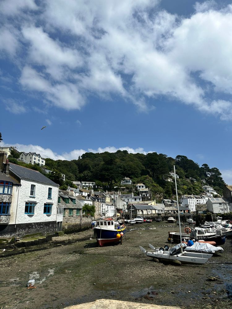 Harbor at low tide, no water, surrounded by little cute fishing village