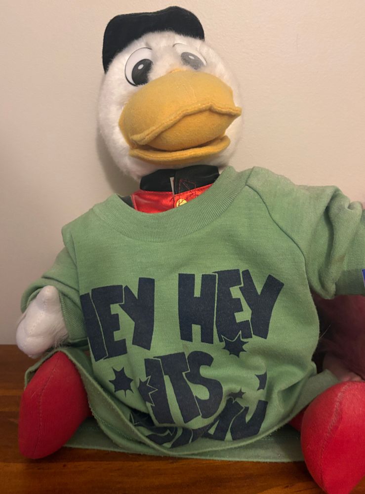 A Plucka Duck toy wearing a green t-shirt with Hey Hey it’s Saturday in 70s style font