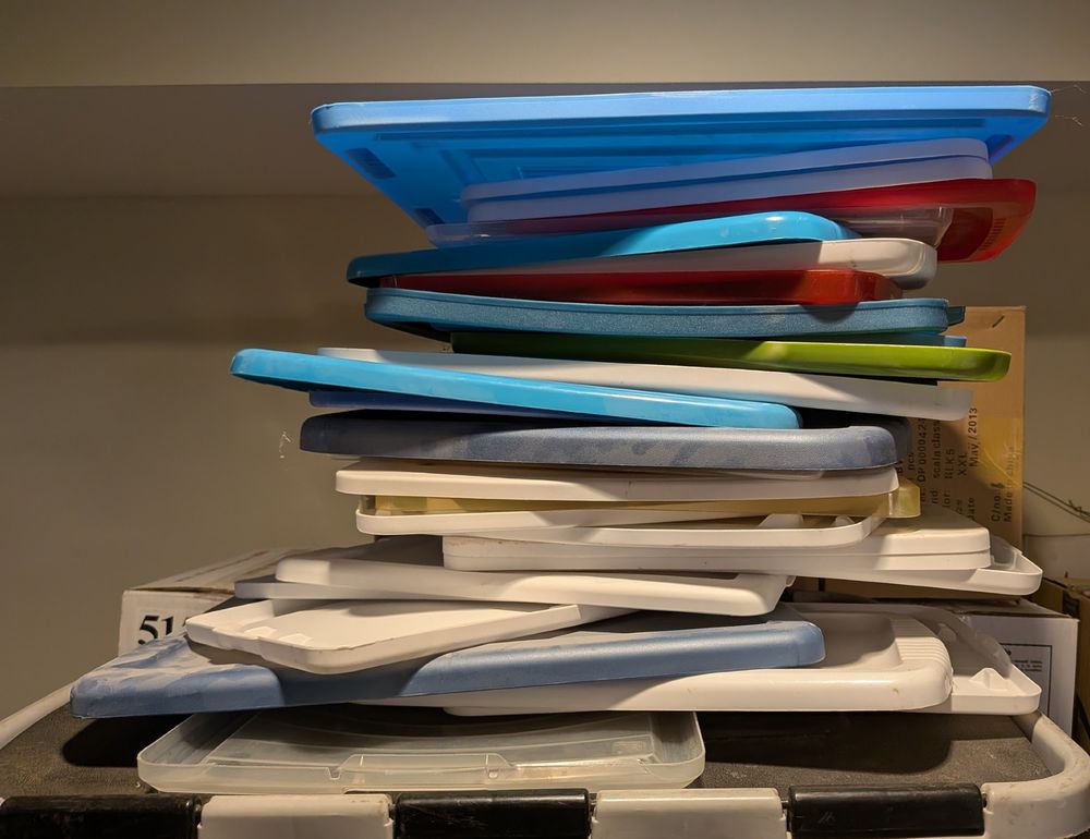 a pile of colored plastic lids for storage containers.