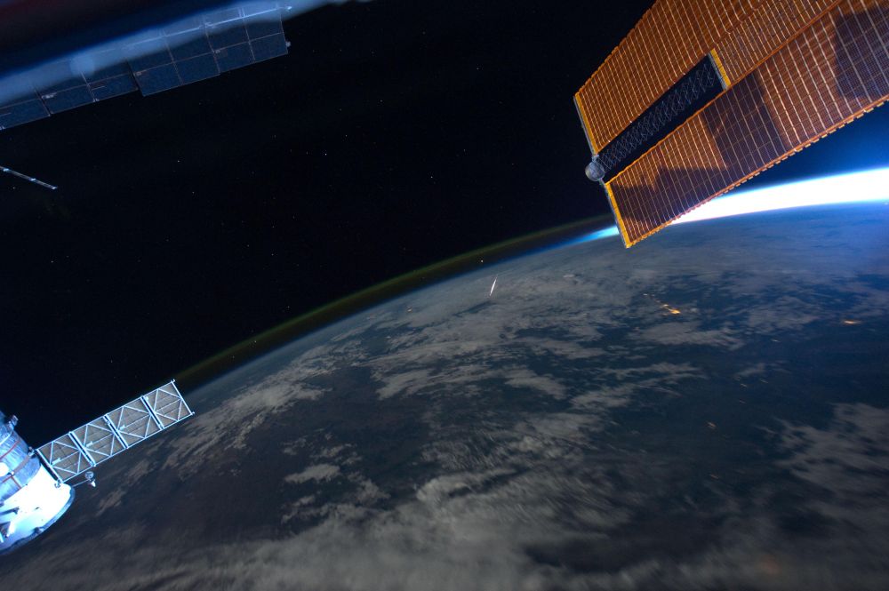 Astronaut Ron Garan, Expedition 28 flight engineer, tweeted this image from the International Space Station on Aug. 14 with the following caption: "What a 'Shooting Star' looks like from space, taken yesterday during Perseid Meteor Shower." The image was photographed from the orbiting complex on Aug. 13 when it was over an area of China approximately 400 kilometers to the northwest of Beijing. The rare photo opportunity came as no surprise since the Perseid Meteor Shower occurs every year in August. The meteors are particles that originate from the comet Swift-Tuttle along its orbital path; the comet's orbit is close enough for these particles to be swept up by the Earth's gravitational field each year. Green and dim yellow airglow appears as thin layers visible above the limb of the Earth, extending from image left to upper image right. Atoms and molecules above 50 kilometers in the atmosphere are excited by sunlight during the day, and then release this energy at night producing primarily green light observable from orbit. The sun is low on the horizon as it appears near part of one of the station's solar panel arrays at image upper right.