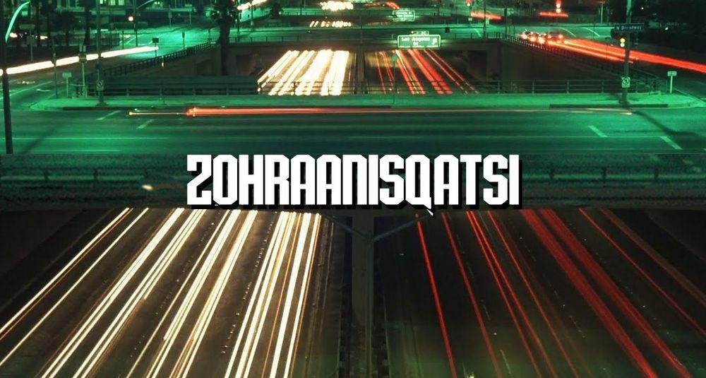 Title card for Koyaanisqatsi, with the name of the movie superimposed on a long exposure of a complex highway intersection at night, except it's Zohraanisqatsi.