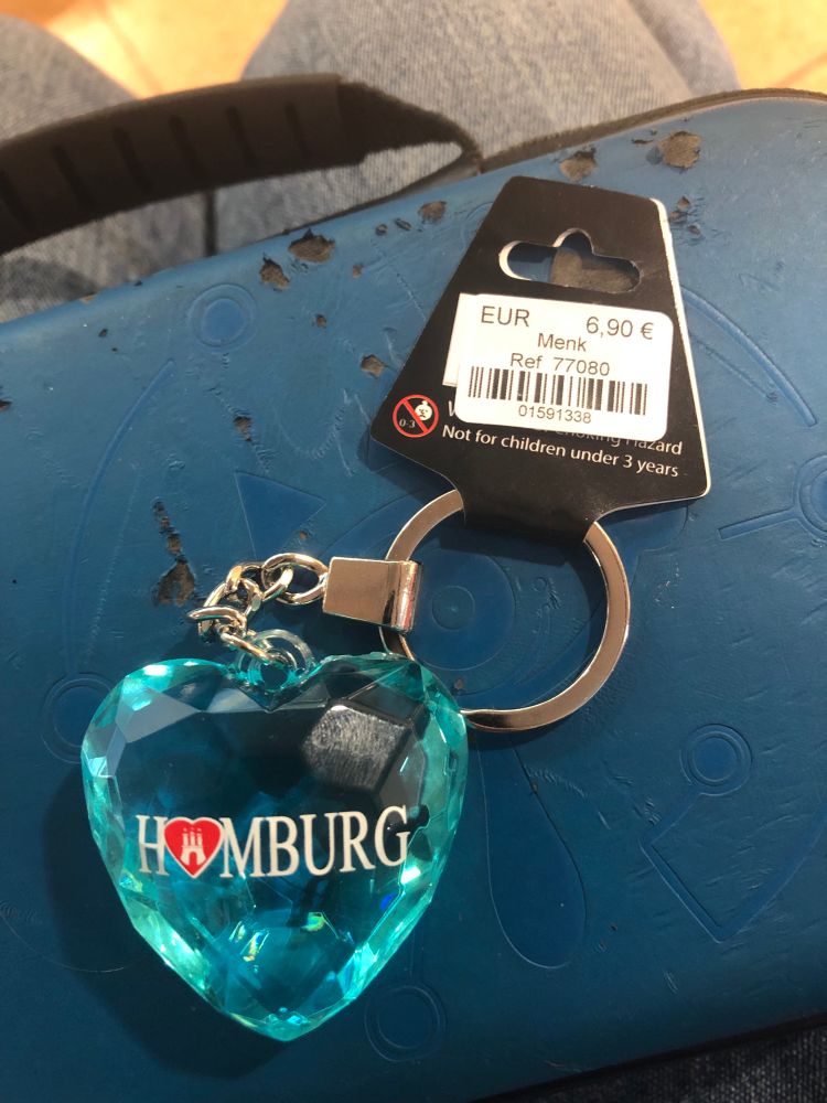 a small, light blue crystal looking heart keychain that says "HAMBURG" with the "A" replaced by a red heart