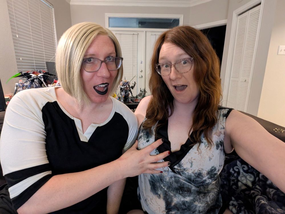 A humorous shot of Rachel grabbing Janey's right boob. 