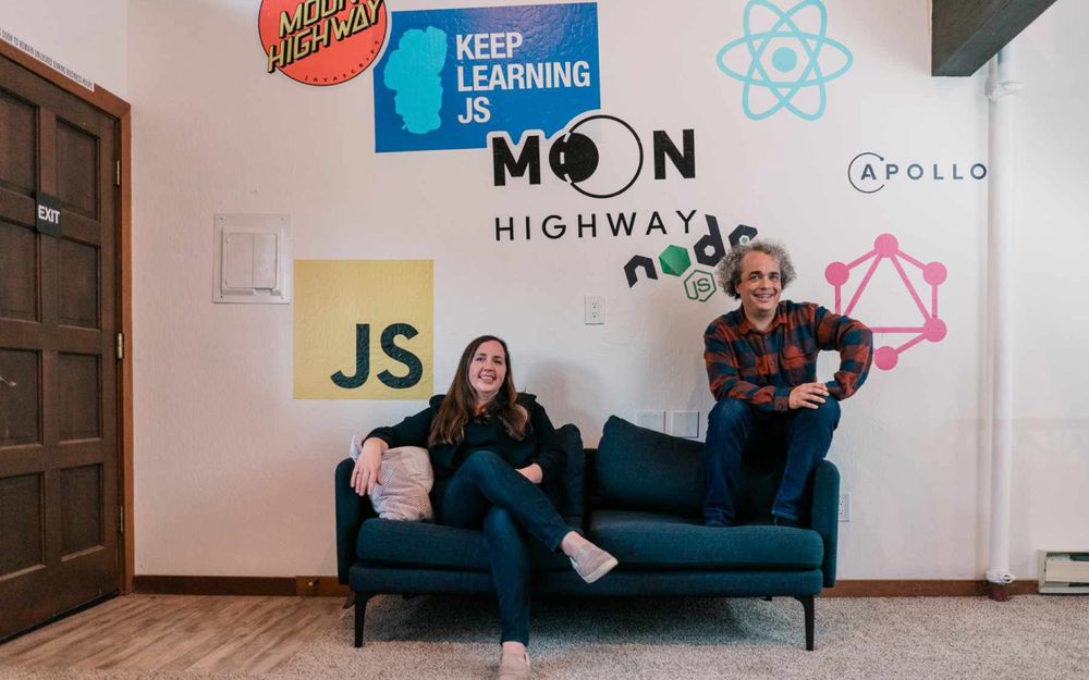 Alex Banks and Eve Porcello of Moon Highway sitting on a blue sofa.