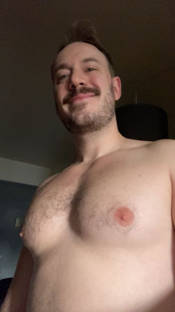I’m looking down at the camera in a selfie smirking, tiddies out and well lit.