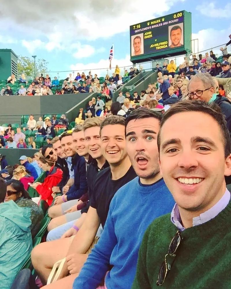 A bunch of similar looking white dudes attend a tennis match, all in the same row. Also a famous meme. 