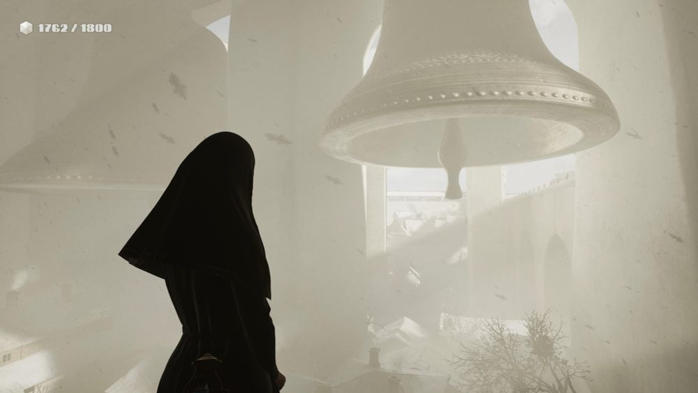 A screenshot from the game Indika. The eponymous main character stands in the foreground, silhouetted in her habit against a background so awash in light as to have lost all color. A pair of truly enormous bells hang in the distance. 