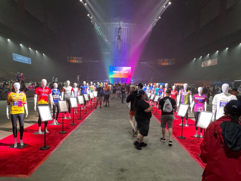 Runway on left and right with mannequins wearing rider jerseys and tshirts
