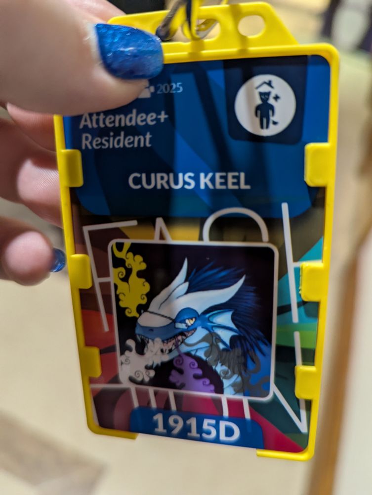 Image of a convention badge displaying an icon of the blue dragon Curus Keel