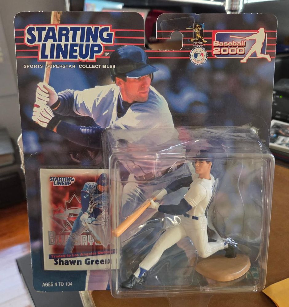 Starting Lineup package from 2000 displaying a Shawn Green collectible figurine and a trading card of Green in action with the Blue Jays, with a blurb above his name that says "Traded to Los Angeles Dodgers".