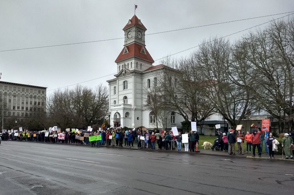 Corvallis Oregon 2/17/25 protest photo of crowd with signs in front of the Benton county courthouse