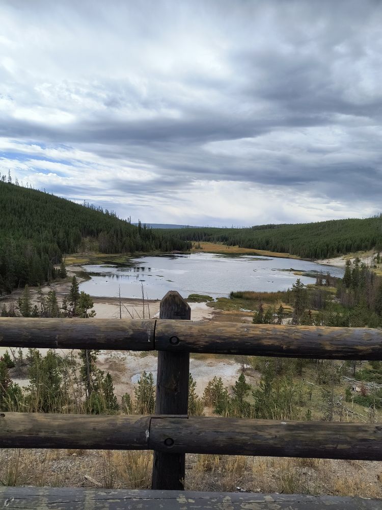 Lake in the background with a wooden fence in the foreground.