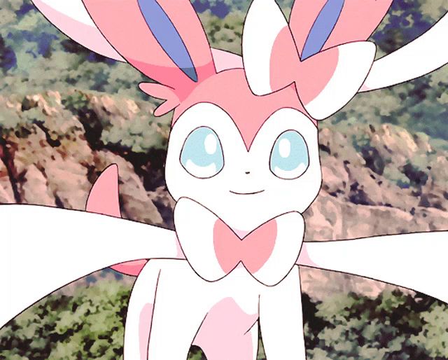 a pink and white bunny with blue eyes and a bow on its neck