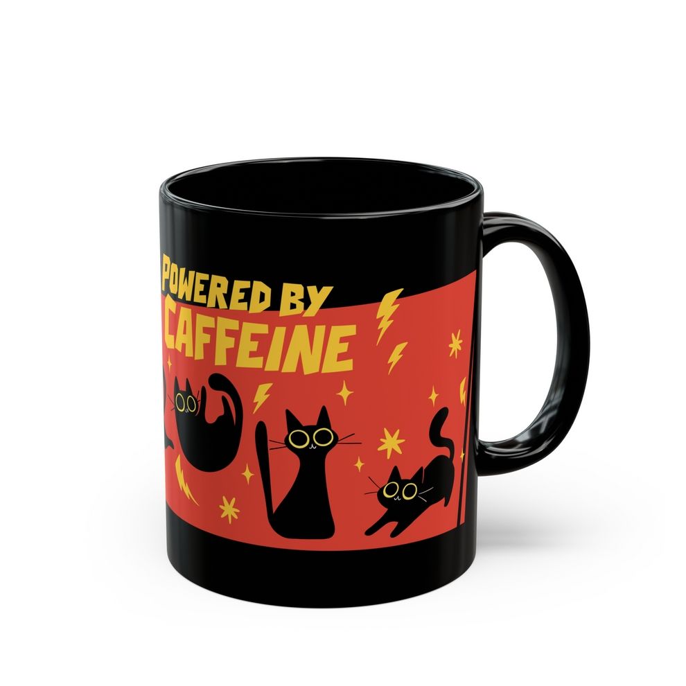 A black ceramic mug depicting four energetic black cats with big dilated eyes and yellow sparks around them. The text above says "powered by caffeine". 