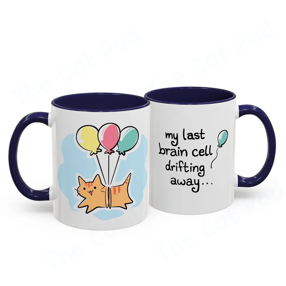 Mug featuring a clueless orange cat floating with three colorful balloons tied to him. The text on the other side says "my last brain cell drifting away" with another balloon floating away. 