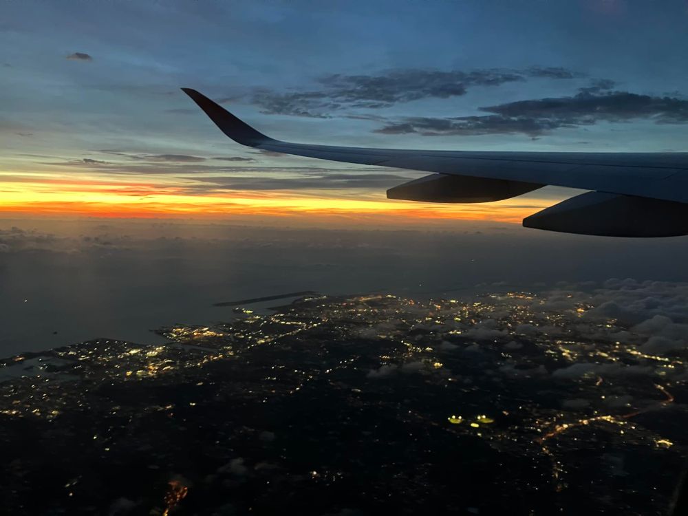 leaving Naha, orange line of sunset and lights of Naha city