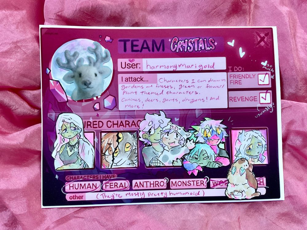 Photo of this year’s Art Fight card (team crystals), printed out, so that I could add my art to it traditionally. It features drawings of my characters cut and glued to the card, and a photo of a felted dear for my icon. The section for what I’ll attack I wrote “characters I can draw in gardens and forests, green or flower/plant themed characters. Canines, deers, goats, dragons! And more!”