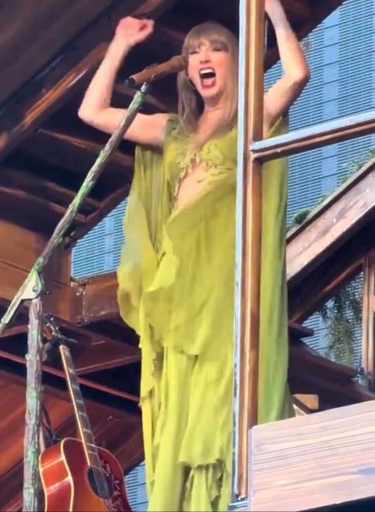 taylor swift cheering on stage at the eras tour during the folkmore set