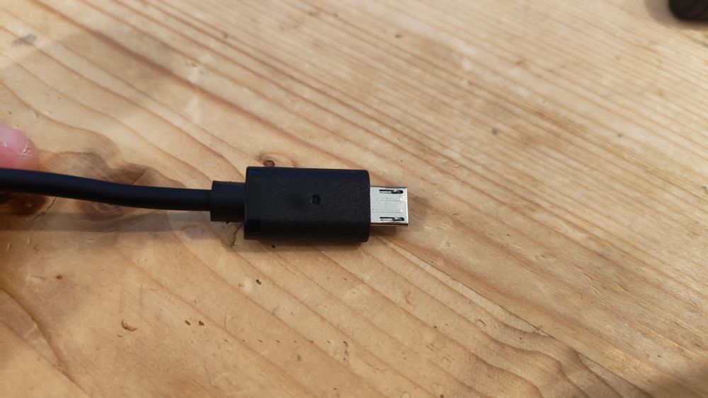 A micro USB cable. The black plastic around the connector is bubbled up