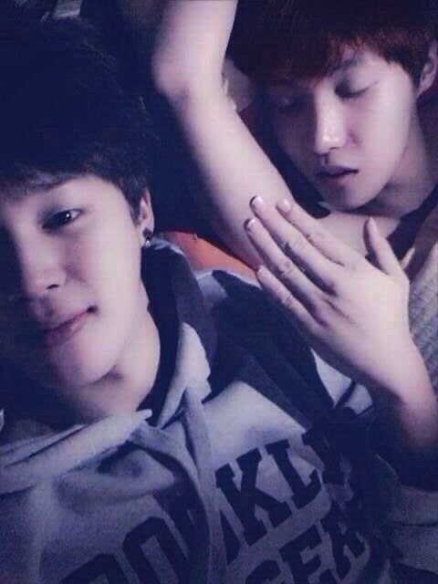A wild jihope debut era photo from f Hobi sleeping and Jimin taking a selfie next to him covering Hobis would be exposed armpit 