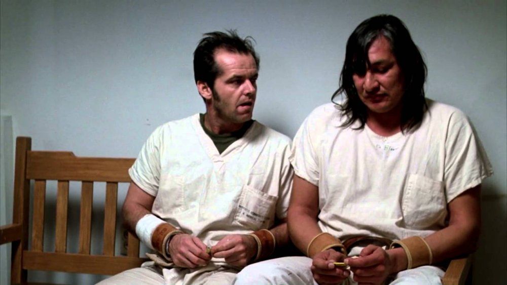 Two patients sitting together on a bench. 

Mac (Jack Nicholson) has just offered Chief (Will Sampson) some gum and Chief reveals he can speak.