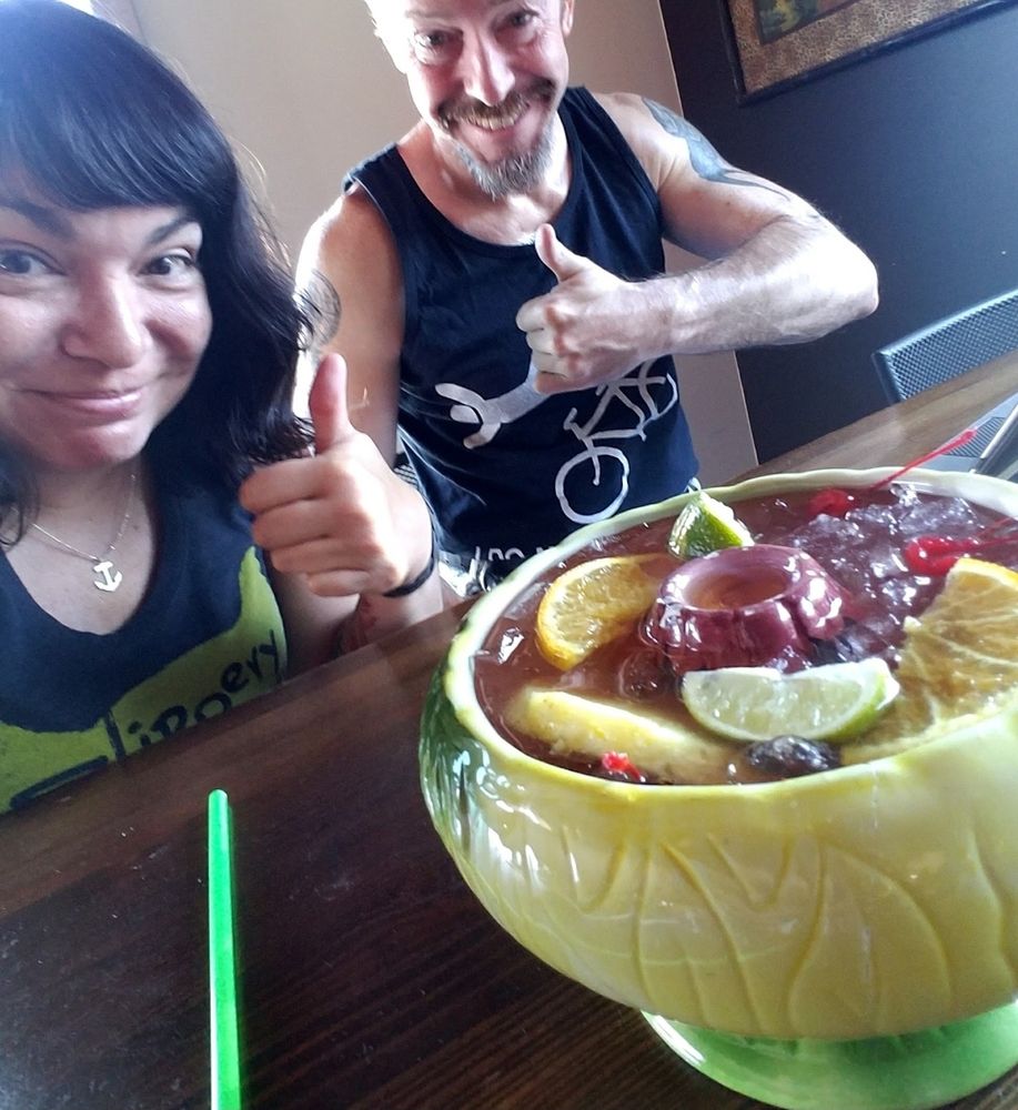 Karla and Stuntdiiick giving thumbs up with a huge ass tiki drink in front of them