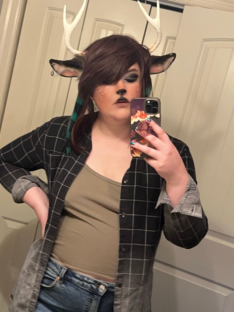a mirror selfie of me in the same cosplay except i am wearing a checkered black flannel that fades into grey 