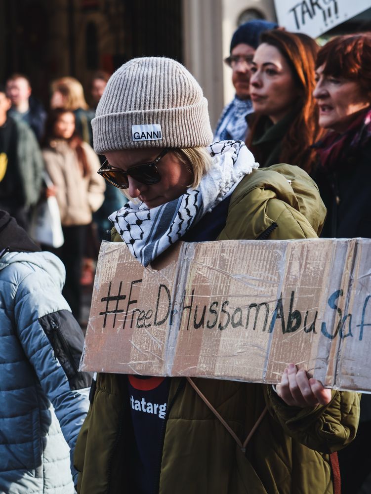Healthcare workers with a sign #freedrhussam