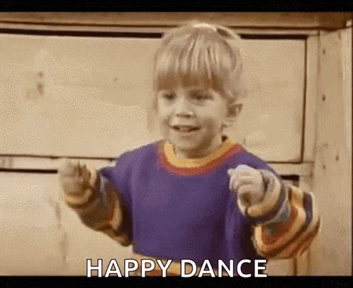 a little boy is dancing and pointing at the camera with the words `` happy dance '' written below him .