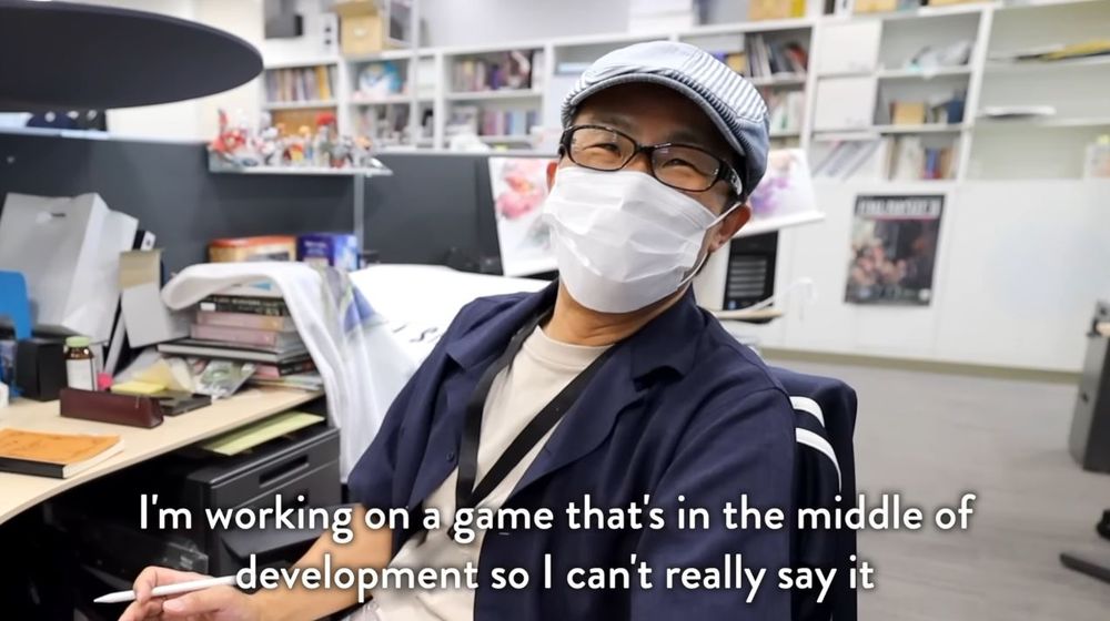 Final Fantasy IX character designer Toshiyuki Itahana saying: "I'm working on a game that's in the middle of development so I can't really say it."
FF9 figurines in the background.