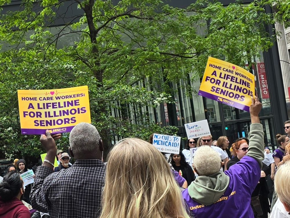 Crowd at an outdoor rally. People hold sign saying home care workers: a lifeline for Illinois seniors