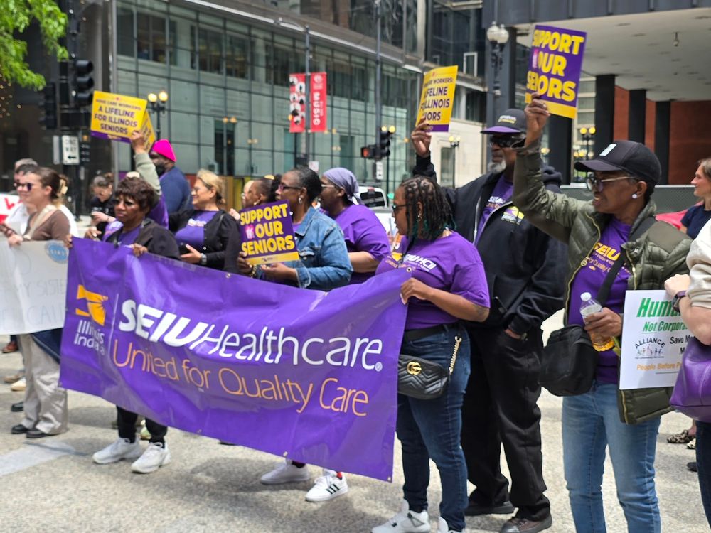 SEIU union workers at an outdoor demonstration with a banner that says SEIU Healthcare Illinois, Indiana. United for quality care