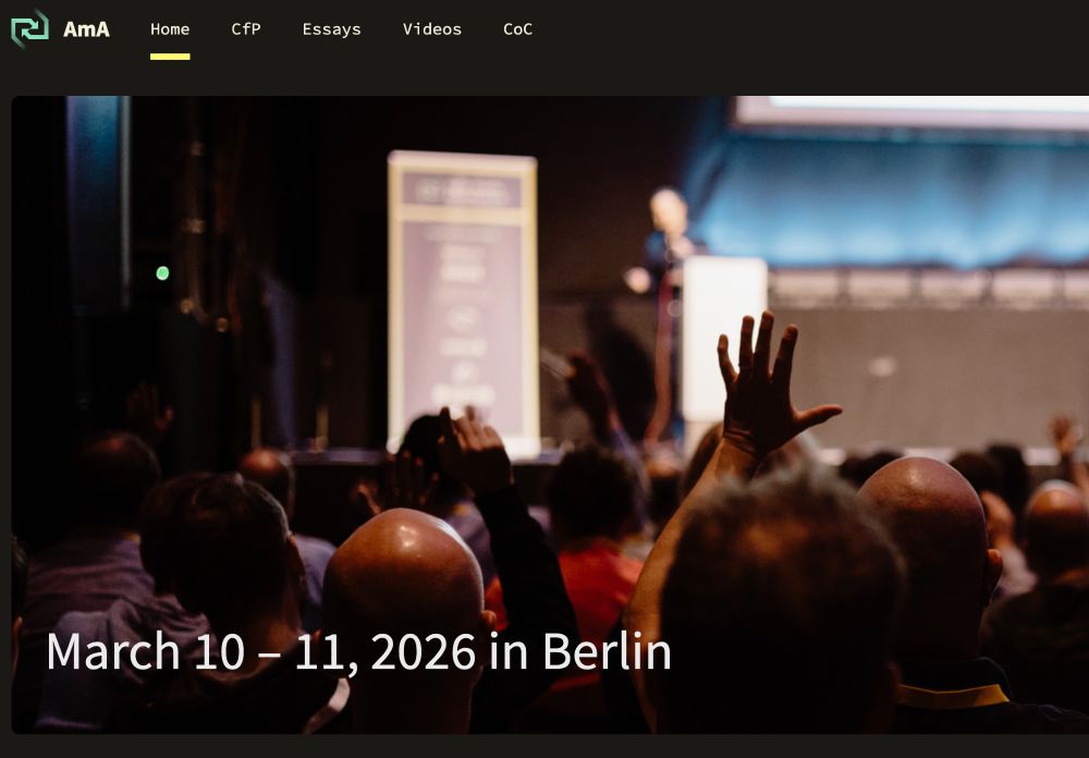 A picture of the conference audience with people rasing hands. Also states the date of the conference March 10-11, 2026 Berlin.