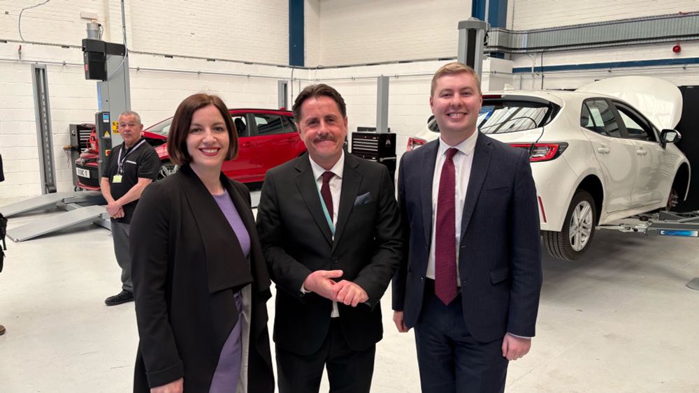 Photograph showing Rt Hon Bridget Phillipson MP, Secretary of State for Education, with Jacob Collier MP, Member of Parliament for Burton & Uttoxeter, and John Beaty, Principal, in the automotive training facilities at Burton & South Derbyshire College. Burton, April 2025.