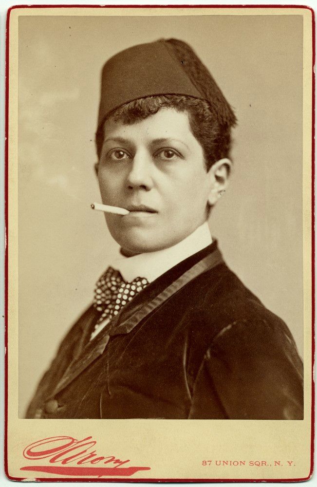 Another carte portrait, also as a young man, wearing short hair, a hat, smoking a cigarette, wearing a jacket and a polka dot bow tie.