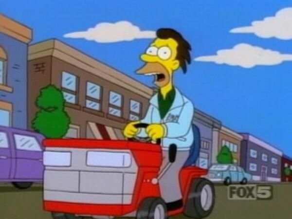 Lenny from The Simpsons riding what looks like a ride on mower. 