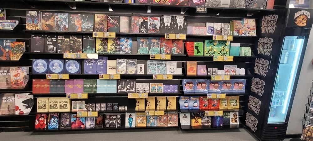 A photo of the back wall of forbidden Planet Dublin, featuring dozens of books from local artists