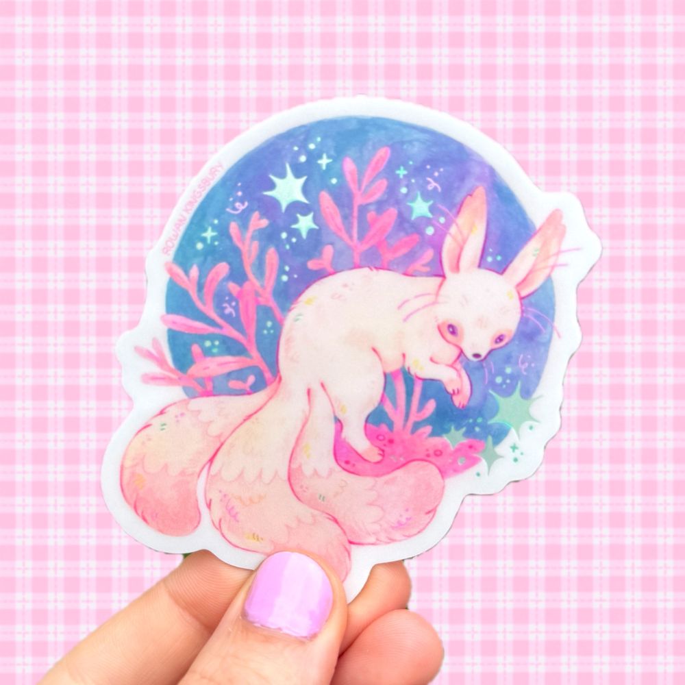 A sticker design of the above painting being held above a pink checkered background.