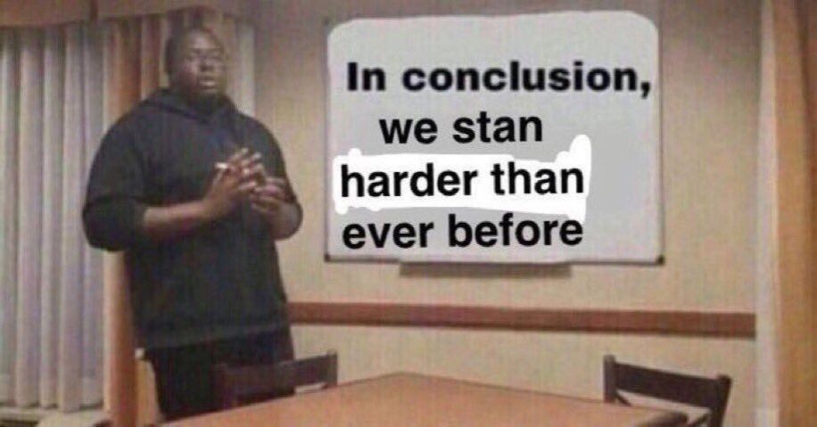 Photo of Black man wearing hoodie giving a presentation standing in front of a whiteboard that says, "In conclusion we stan harder than ever before"