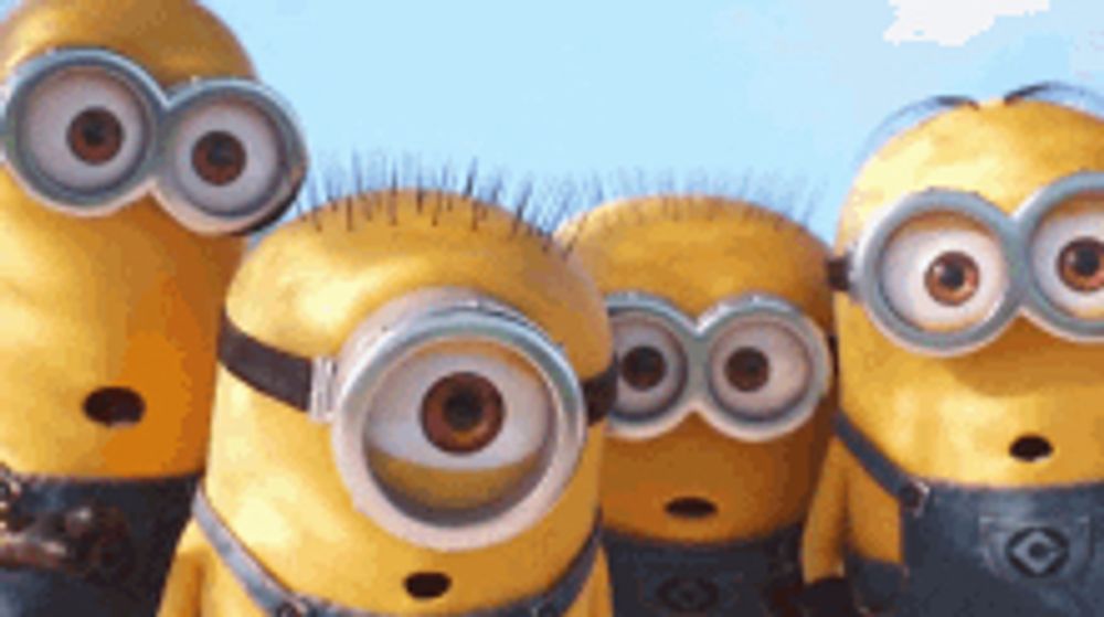 a group of minions wearing goggles and overalls are standing next to each other .