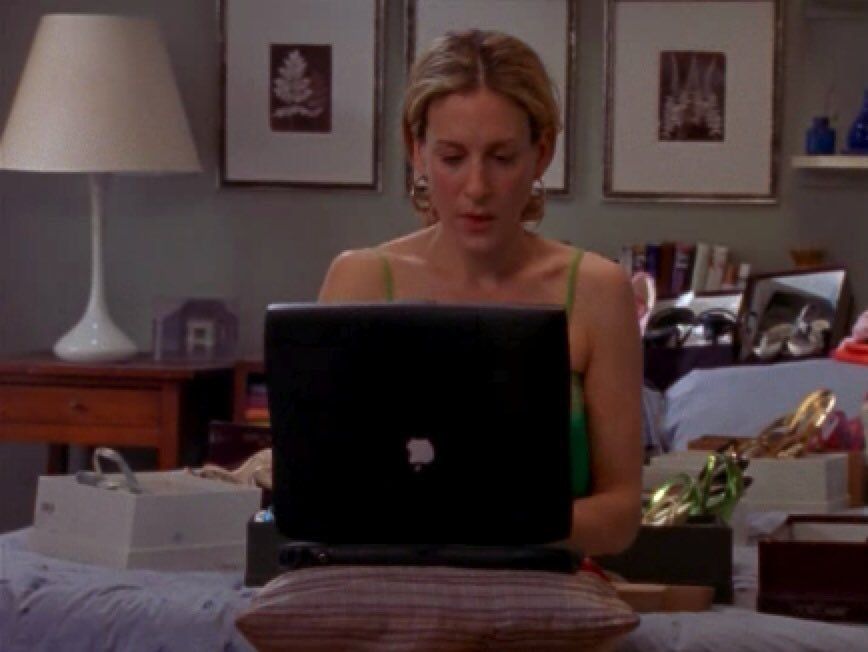Carrie Bradshaw from Sex and the City typing at her laptop