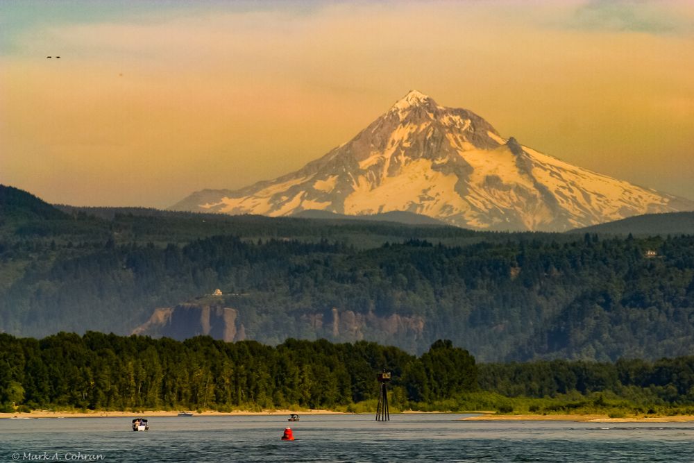 Mount Hood as seen from a boat on the Columbia River at sunset.