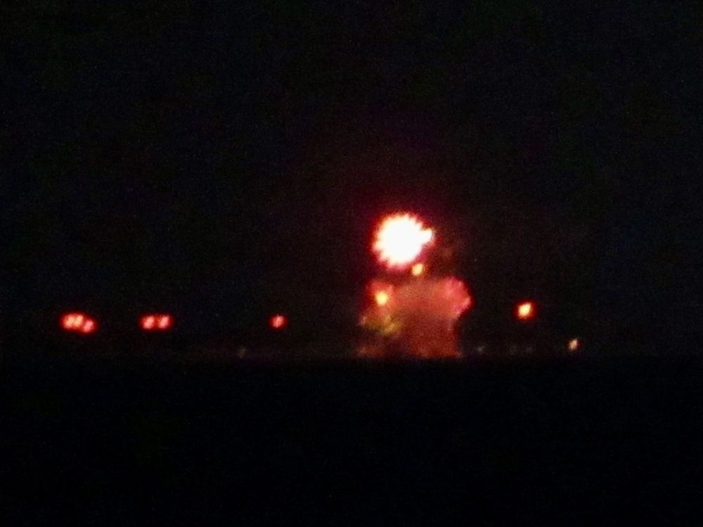 Bright red fireworks explode against a dark night sky.